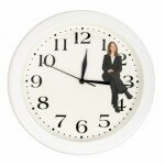 stockfresh_285081_business-woman-sitting-on-clock_sizeXS