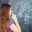 stockfresh_1719777_pretty-young-college-student-writing-on-the-chalkboard_sizeXS