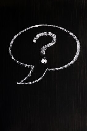 Chalk drawing of speech bubble with question mark